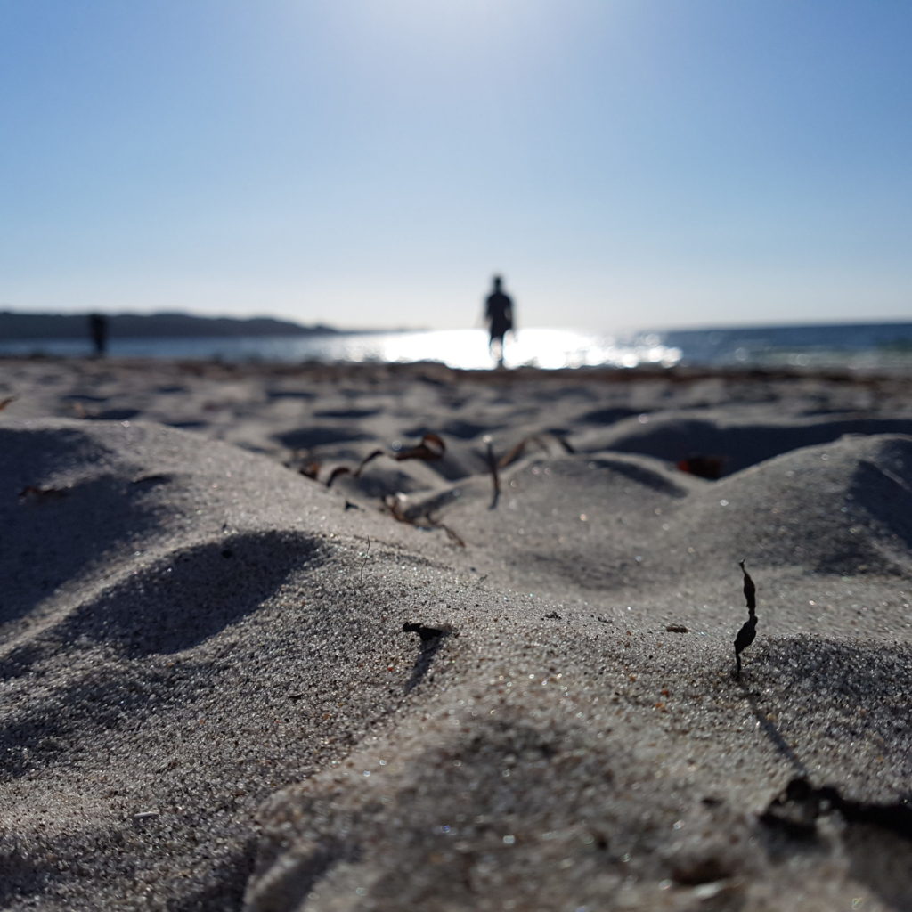 silhouette of person wandering along the beach, illustrating mindfulness meditation