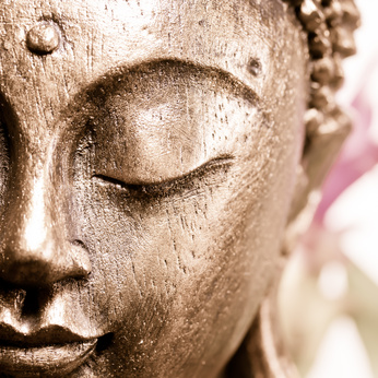 closed eye of a Buddhist statue, representing mindfulness guidance